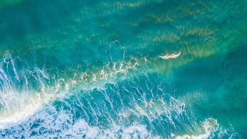 water aerial photography of sea waves during daytime sea