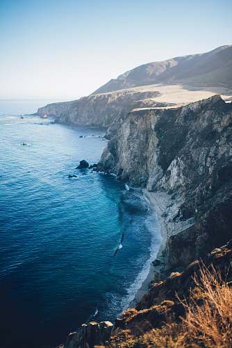ocean photo of cliff near shore cliff