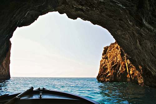 nature boat inside of water cave water