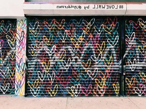 graffiti photo of black door shutter filled with heart murals love