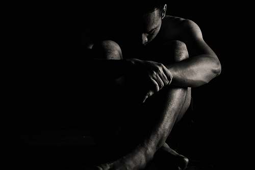 indonesia man sitting on black surface outer space