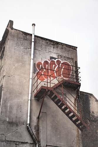 handrail gray concrete building with metal stairs graffiti