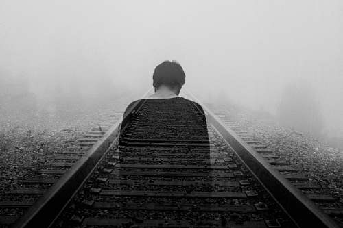 ghost grayscale photo of man wearing black shirt fade away