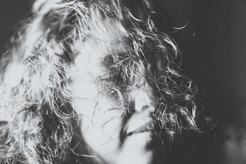 grey grayscale photography of a woman's face covered with her hair depression