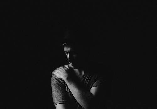 man man holding his left shoulder shadow