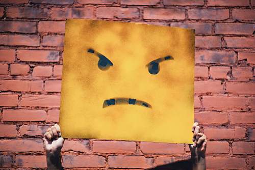 orange angry face illustration wall