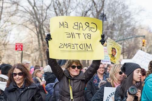 parade woman raise signage person