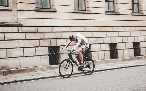 bicycle man wearing gray t-shirt and gray shorts cycling bike