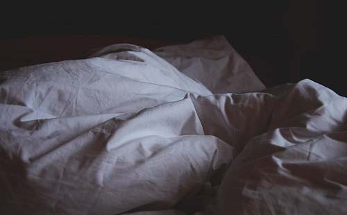 bed closeup photo of white blanket pillow