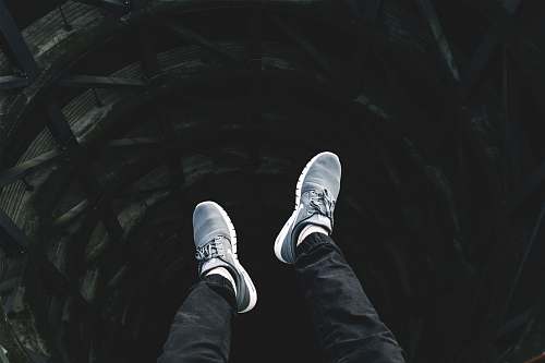 shoes person showing pair of gray lace-up low-top sneakers shoe