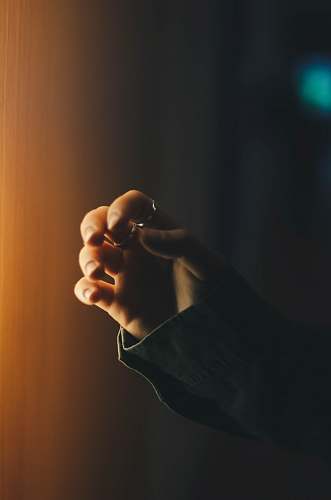rings person wearing two silver-colored rings on left fingers sleeve