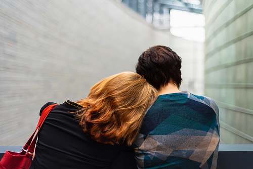 person man and woman standing near gray metal fence people