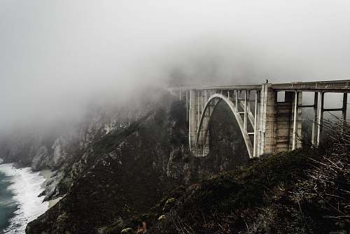 bridge white concrete bridge covered with fogs cloud