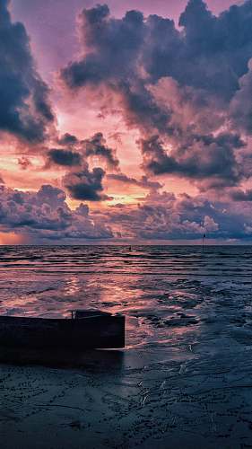 outdoors canoe on beach during golden hour cloud