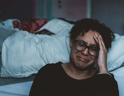 person person crying beside bed human