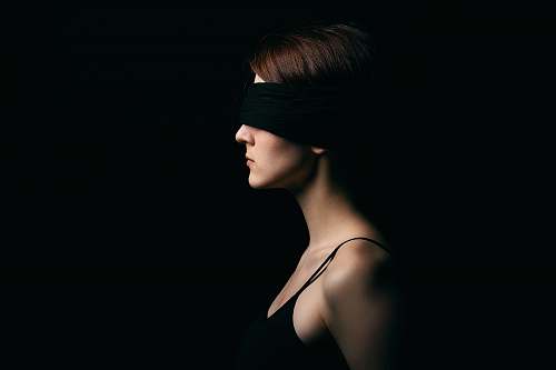 person woman wearing black blindfold facing sideways human