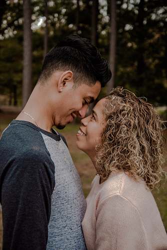 human couple standing face to face closely to each other apparel