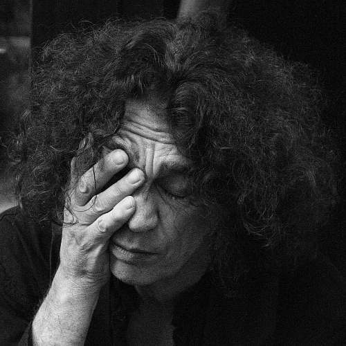 black-and-white grayscale photo of man resting on his hand portrait