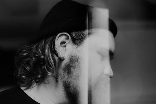 face man in black shirt with beanie cap black-and-white