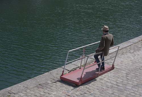 human man leaning on railings banister