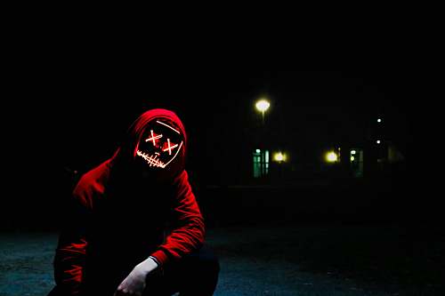 human man squatting during nighttime people