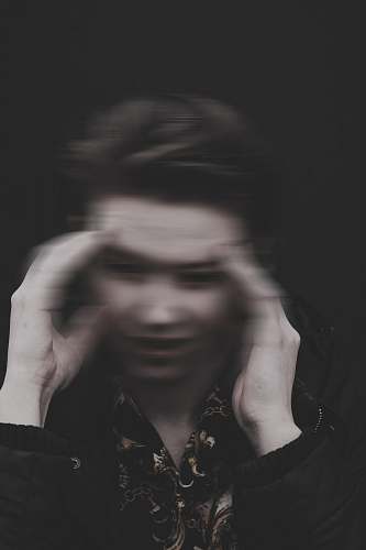 human men holding his head grey-scale photography finger
