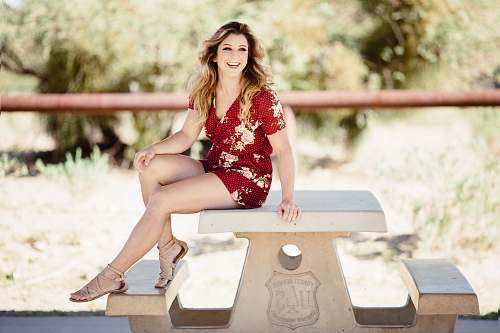 clothing woman sitting on table apparel