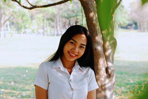 human woman standing beside tree people