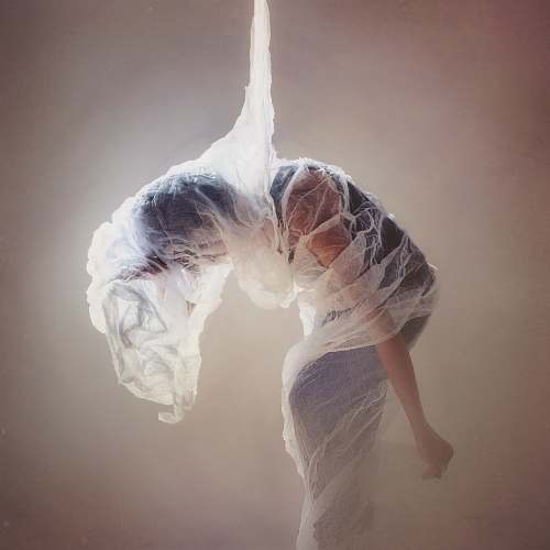 grey woman wrapped on mesh fabric dance