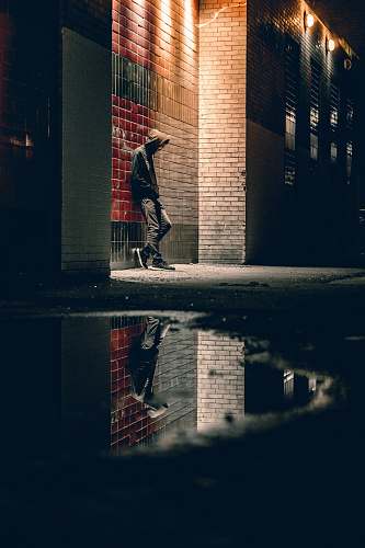 toronto man learning on concrete wall hoodie