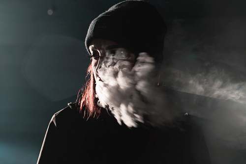 portrait portrait photography of person blowing smoke smoking