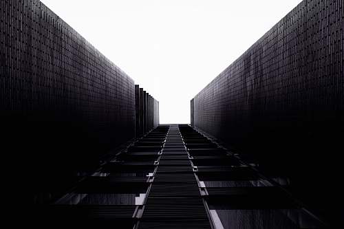 railway grayscale photo of a building train track