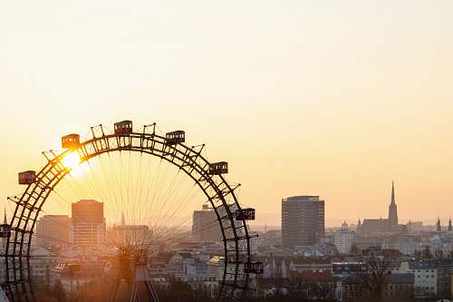 austria ferris wheel near city buildings during sunset amusement park
