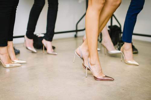 person four woman wearing assorted heels shoe