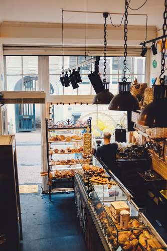 person high-angle photography of bread store by day people