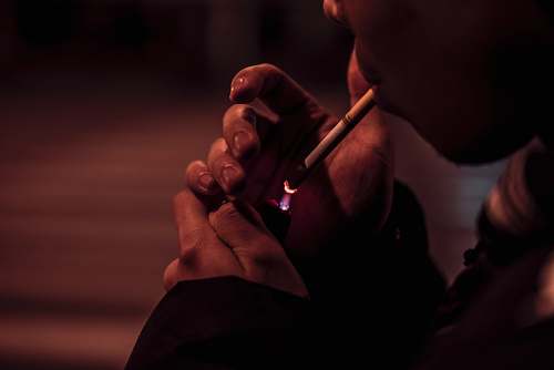 person white cigarette stick finger
