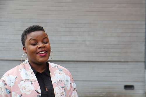 person woman wearing pink blazer smile