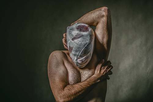 iran topless man covered face with white bandage ornament