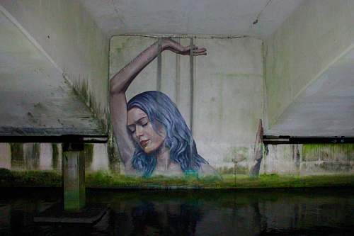 mural blue-haired woman with left hand on hair graffiti west palm beach