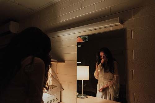 person woman crying in front of mirror human