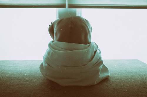human woman sitting on black surface inside room person