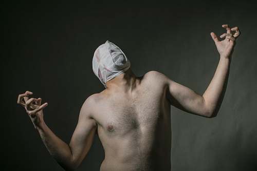 human man face covered with white tape arm