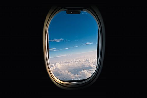 airline window viewing white clouds