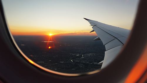 airplanes window view of sky during golden hour