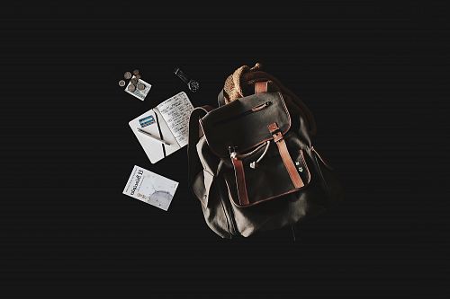 black and brown backpack with black nackground