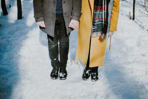 snow person standing beside each oter couple