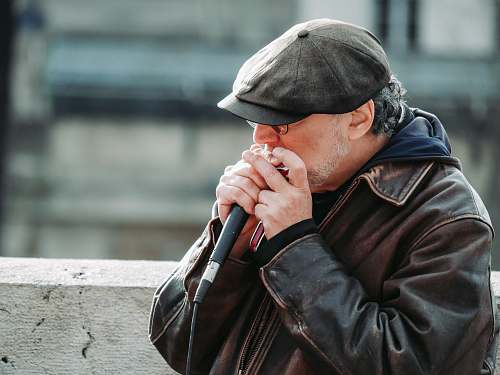 apparel man in black leather jacket holding microphone jacket