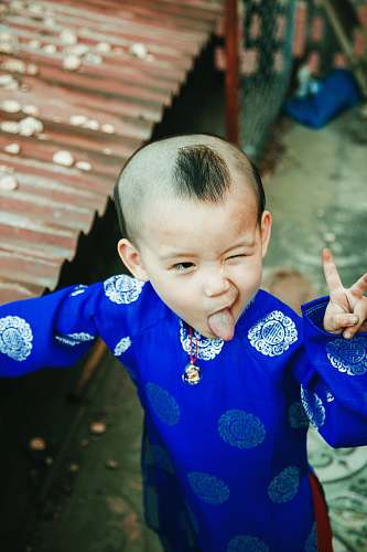person boy doing peace sign people