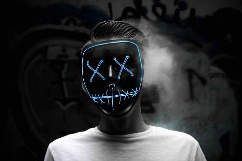 person grayscale photo of man wearing mask people