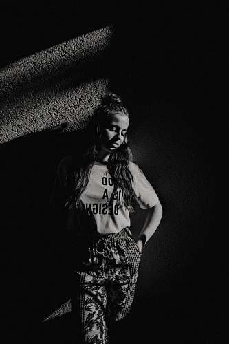 person grayscale photography of girl standing black-and-white